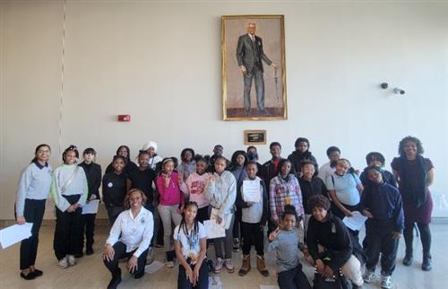 Students and staff stand in front Coleman A Young's picture